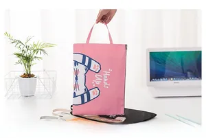 Close-up of pink A4 canvas document bag featuring a cute striped cat illustration
