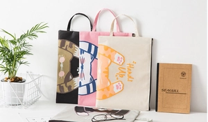 Three minimalist canvas cat-pattern document bags in black, pink and cream white