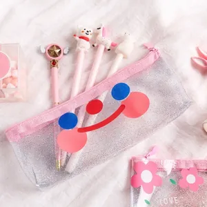 Glitter transparent pencil case with pink zipper and smiley face on white fabric