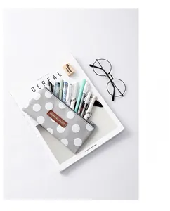 Grey canvas pencil case with white dots showing large capacity for pens and stationery