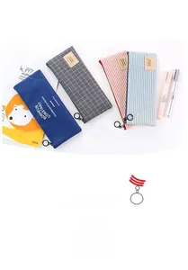 Close-up of four striped fabric pencil cases with metal ring zippers and logo labels