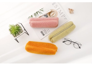 Detailed plush pencil cases in pink, beige, and orange with soft teddy fleece texture