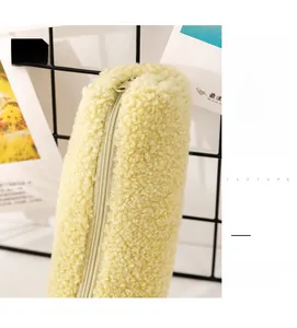 Close-up of soft fluffy teddy fleece pencil case in pale yellow with a sleek metal zipper