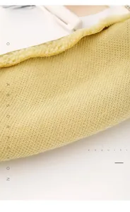 Macro shot of warm yellow fabric lining and plush fleece edges on a stationery pouch