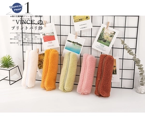 Detailed row of five colorful plush pencil cases in soft lamb wool with matching zippers