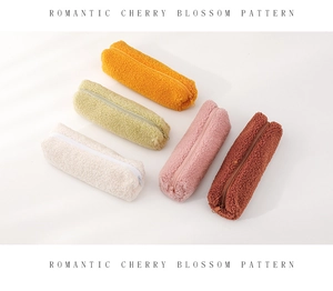 Macro detail of soft sherpa plush pencil cases in diverse pastel colors with zippers