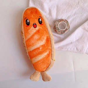 Detailed close-up of cute salmon plush pencil case with zipper and cartoon face