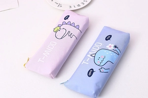 Close-up of purple and blue canvas pencil cases with cartoon dinosaur illustrations