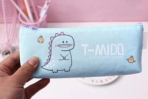 Close-up of light blue canvas pencil case featuring cute cartoon dinosaur and zipper