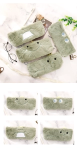 Detail of green plush dinosaur pencil case with soft fur and dinosaur embroidery