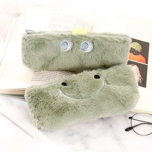 Detailed view of plush dinosaur stationery bags with soft green faux fur and cute embroidery