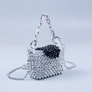 Detail shot of handcrafted acrylic beaded mini bag with silver and black metallic beads