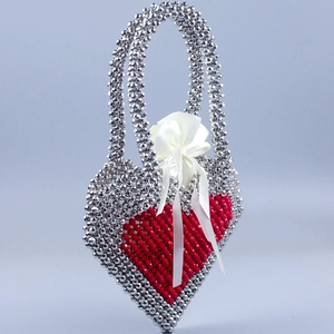 Silver beaded heart handbag with red woven pattern and satin drawstring pouch