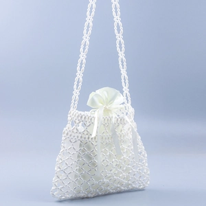 Elegant white pearl beaded crossbody bag with hollow square pattern and satin drawstring pouch