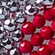 Detailed view of red and silver faceted beads with a glossy reflective coating