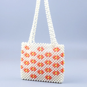 Handmade beaded handbag with daisy flower patterns and white faux pearl weave