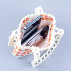 Handmade beaded handbag with lip pattern showing spacious interior for phone and makeup