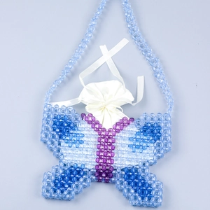 Detailed close-up of handmade butterfly beaded bag with blue and purple crystal beads