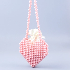 Detail of handmade pink heart-shaped beaded bag with white satin drawstring lining