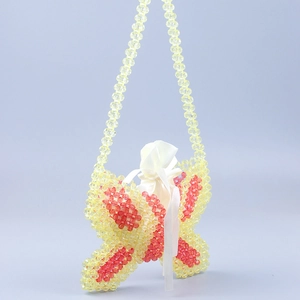 Detail of butterfly-shaped beaded shoulder bag with yellow beads and white satin liner