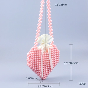 Handmade pink beaded heart-shaped crossbody bag with white satin drawstring lining