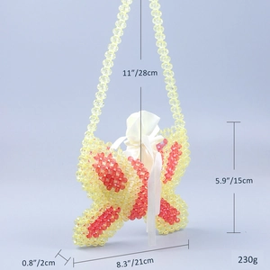 Detail showing butterfly beaded handbag dimensions 21x15x2cm with orange beadwork