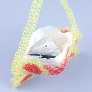 Detail view of the beaded bag interior showing the white satin lining and storage capacity