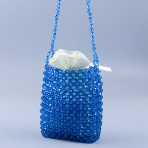 Handmade royal blue beaded crossbody phone bag with a white satin drawstring pouch