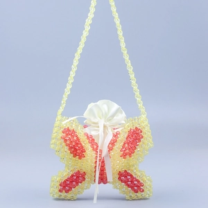 Handmade butterfly beaded bag in yellow and red with a white satin drawstring pouch