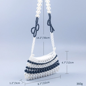 Detailed view of handmade black and white beaded bag with dimensions 22x12x3cm and bow accents
