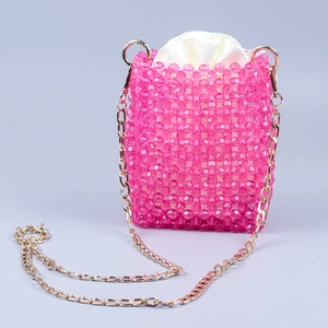 Detail of pink handcrafted beaded bag with satin drawstring liner and gold chain