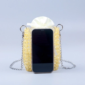 Detail of yellow beaded mini crossbody bag with silver chain and satin drawstring liner