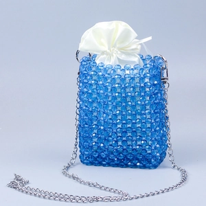 Macro view of blue beaded phone bag with silk inner pouch and silver chain strap
