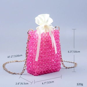 Detailed view of pink beaded crossbody bag with satin drawstring liner and gold chain strap