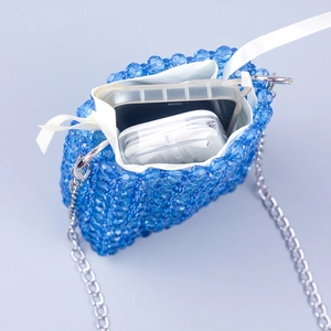 Blue handcrafted beaded mini crossbody bag with silver chain and white drawstring liner