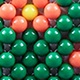 Detail of handmade beaded handbag showing green and orange woven floral pattern