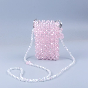 Detail of handmade pink beaded mini crossbody bag featuring crystal heart charms