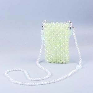 Detail of beaded mini crossbody bag with heart accents and silver ring hardware
