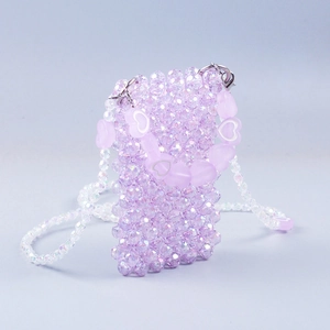 Macro shot of purple beaded crossbody bag showing faceted beads and heart-shaped handle