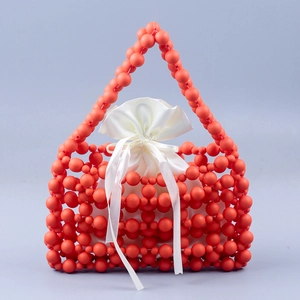 Handmade coral orange beaded handbag with large round beads and white satin drawstring pouch