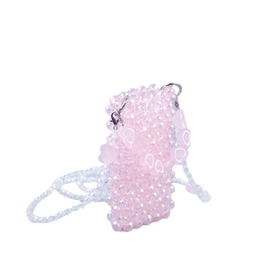 Handmade pink beaded mini crossbody bag with white heart accents on a white background