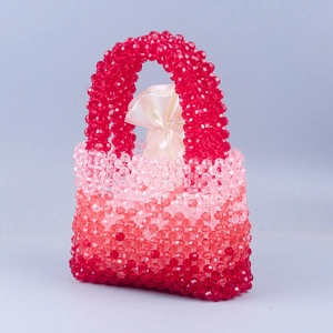 Detailed macro shot of handmade beaded handbag with red gradient crystals and satin lining