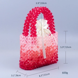 Detail of handmade beaded handbag showing red gradient weave and white satin drawstring liner