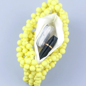 Handmade yellow beaded tote bag with white fabric lining showing interior storage space