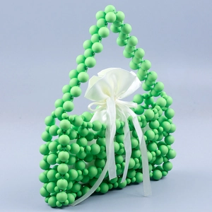 Detail of fruit green beaded handbag featuring frosted resin beads and satin drawstring bag