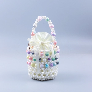 Detail of handmade pearl beaded bucket bag with colorful tie-dye accents and satin liner