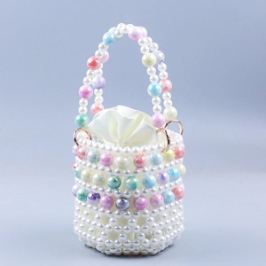 Detail of handmade beaded bucket bag with white pearls and marble pattern beads