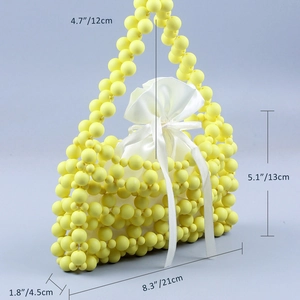 Detailed dimensions of yellow beaded handbag with white satin drawstring inner bag