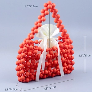 Detail of orange beaded handbag with white satin drawstring pouch and size measurements