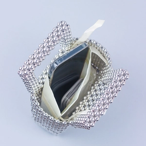 Handmade silver beaded tote bag with satin drawstring liner showing phone capacity